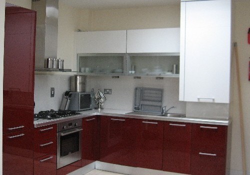 Photograph of wood and white kitchen at Hartys Quay Apartments